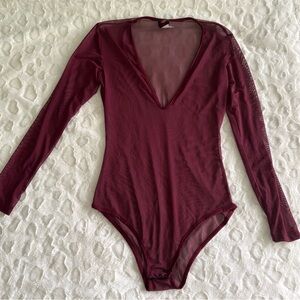 NWOT USA Vintage Burgundy Sheer Long Sleeve Bodysuit in Size Medium.